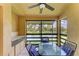 Relaxing screened patio with fan, table and seating overlooking a tranquil lake at 5728 Ashton Lake Dr # 12, Sarasota, FL 34231