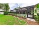 A beautiful home with lush landscaping, a view of the pool, and covered outdoor patio at 6107 Misty Oaks St, Sarasota, FL 34243