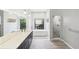 Bathroom with dual sink vanity, soaking tub, glass enclosed shower, and natural light at 6107 Misty Oaks St, Sarasota, FL 34243