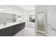 Bathroom with dual sink vanity, soaking tub, glass enclosed shower, and neutral walls at 6107 Misty Oaks St, Sarasota, FL 34243