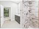 Updated bathroom with gray vanity, double sinks, and stylish tiled shower at 6107 Misty Oaks St, Sarasota, FL 34243