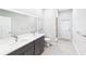 Contemporary bathroom boasts double sinks, large mirror, and tiled walk-in shower at 6107 Misty Oaks St, Sarasota, FL 34243