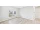 Bright, minimalist bedroom with a large window and modern flooring at 6107 Misty Oaks St, Sarasota, FL 34243