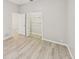 Charming bedroom featuring luxury vinyl plank flooring, neutral walls, and an open closet at 6107 Misty Oaks St, Sarasota, FL 34243