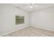 Bright bedroom featuring luxury vinyl plank flooring, neutral walls, and modern ceiling fan at 6107 Misty Oaks St, Sarasota, FL 34243