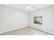 Bright bedroom featuring luxury vinyl plank flooring, neutral walls, and a window at 6107 Misty Oaks St, Sarasota, FL 34243