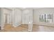 Bright entryway features decorative glass front door, hardwood floors, and neutral color scheme at 6107 Misty Oaks St, Sarasota, FL 34243