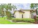 A beautiful home with lush landscaping and a view of the pool out back at 6107 Misty Oaks St, Sarasota, FL 34243