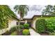 Inviting single-story home with lush landscaping and a stone-accented entryway at 6107 Misty Oaks St, Sarasota, FL 34243