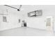Spacious two car garage featuring neutral colored walls, water heater, and garage door opener at 6107 Misty Oaks St, Sarasota, FL 34243