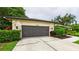 Attached two car garage featuring stone veneer and modern lighting at 6107 Misty Oaks St, Sarasota, FL 34243