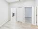 Hallway with wood floors connecting to a laundry room, closet and bedroom at 6107 Misty Oaks St, Sarasota, FL 34243