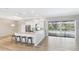 Open-concept kitchen with counter seating and views of the outdoor pool area at 6107 Misty Oaks St, Sarasota, FL 34243