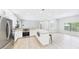 Open concept kitchen showcases stainless steel appliances, center island, and seamless flow at 6107 Misty Oaks St, Sarasota, FL 34243