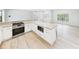 Spacious kitchen with stainless steel appliances, a center island, and ample countertop space at 6107 Misty Oaks St, Sarasota, FL 34243