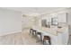 Bright, open kitchen and breakfast bar area featuring stainless steel appliances and light-colored cabinetry at 6107 Misty Oaks St, Sarasota, FL 34243