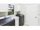 Laundry room featuring newer washer and dryer, utility sink, and window at 6107 Misty Oaks St, Sarasota, FL 34243