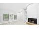 Bright living area with wood floors, fireplace, and large windows offering ample natural light at 6107 Misty Oaks St, Sarasota, FL 34243