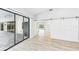 A modern open-concept living space with sliding glass doors and a large barn door entrance to another room at 6107 Misty Oaks St, Sarasota, FL 34243
