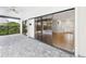 Covered patio featuring stone pillars and a view of the swimming pool with sliding doors that lead into the home at 6107 Misty Oaks St, Sarasota, FL 34243