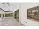 Spacious covered patio with tile flooring, ceiling fans, sliding glass doors and a window overlooking the kitchen at 6107 Misty Oaks St, Sarasota, FL 34243