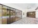 Spacious covered patio featuring tile flooring, ceiling fans and sliding doors that lead to the pool at 6107 Misty Oaks St, Sarasota, FL 34243