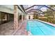 A lovely covered pool is surrounded by beautiful pavers and has direct access to the main house at 6107 Misty Oaks St, Sarasota, FL 34243