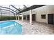 A lovely covered pool is surrounded by beautiful pavers and has direct access to the main house at 6107 Misty Oaks St, Sarasota, FL 34243