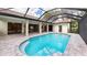 A beautiful covered pool is surrounded by beautiful pavers and has direct access to the main house at 6107 Misty Oaks St, Sarasota, FL 34243