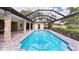A lovely covered pool is surrounded by beautiful pavers and has direct access to the main house at 6107 Misty Oaks St, Sarasota, FL 34243