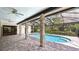 A lovely covered pool is surrounded by beautiful pavers and has direct access to the main house at 6107 Misty Oaks St, Sarasota, FL 34243