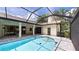 A lovely covered pool is surrounded by beautiful pavers and has direct access to the main house at 6107 Misty Oaks St, Sarasota, FL 34243