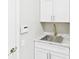 Utility sink with modern fixtures and storage in laundry room at 6107 Misty Oaks St, Sarasota, FL 34243
