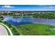 Picturesque aerial view of a lake surrounded by lush greenery and residential neighborhoods, highlighting waterfront living at 6302 Anise Dr, Sarasota, FL 34238