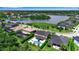 Stunning aerial view of a residential area with a lake, showcasing lush greenery, well-maintained homes, and serene surroundings at 6302 Anise Dr, Sarasota, FL 34238