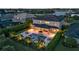 Aerial view of backyard featuring a pool, spa, covered patio and landscaped greenery overlooking the lake at 6302 Anise Dr, Sarasota, FL 34238