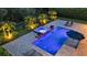 Aerial view of a luxurious pool and spa area with palm trees and landscaped greenery at 6302 Anise Dr, Sarasota, FL 34238