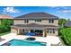Expansive backyard featuring a sparkling pool, brick-paved patio, and outdoor dining area perfect for entertaining at 6302 Anise Dr, Sarasota, FL 34238