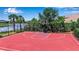 A private outdoor basketball court with a view of the pond and lush landscaping at 6302 Anise Dr, Sarasota, FL 34238