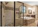 Elegant bathroom featuring a soaking tub with decorative stone and separate glass shower at 6302 Anise Dr, Sarasota, FL 34238