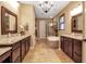 Luxurious bathroom with dual vanities, granite countertops, a soaking tub, and a separate glass-enclosed shower at 6302 Anise Dr, Sarasota, FL 34238