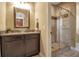 Bathroom featuring granite counters and a tiled walk-in shower at 6302 Anise Dr, Sarasota, FL 34238