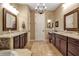 Elegant bathroom with dual sinks, granite counters, and a chandelier, offering a spa-like experience at 6302 Anise Dr, Sarasota, FL 34238