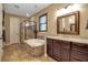 Elegant bathroom featuring a soaking tub with decorative stone and separate glass shower at 6302 Anise Dr, Sarasota, FL 34238