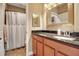 Functional bathroom featuring a dark granite countertop and dark wood cabinets at 6302 Anise Dr, Sarasota, FL 34238