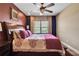 Cozy bedroom with burgundy accents, a ceiling fan, and natural light at 6302 Anise Dr, Sarasota, FL 34238
