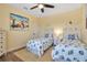 Bright bedroom with two twin beds, beach themed decor and light yellow walls at 6302 Anise Dr, Sarasota, FL 34238