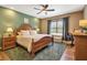 Bedroom with green accent wall, natural wood furniture, and ample natural light at 6302 Anise Dr, Sarasota, FL 34238