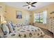 Bright bedroom with beach decor, ceiling fan, and comfortable twin beds at 6302 Anise Dr, Sarasota, FL 34238