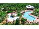 Aerial view of community pool with playground, lounge chairs, and open-air clubhouse at 6302 Anise Dr, Sarasota, FL 34238
